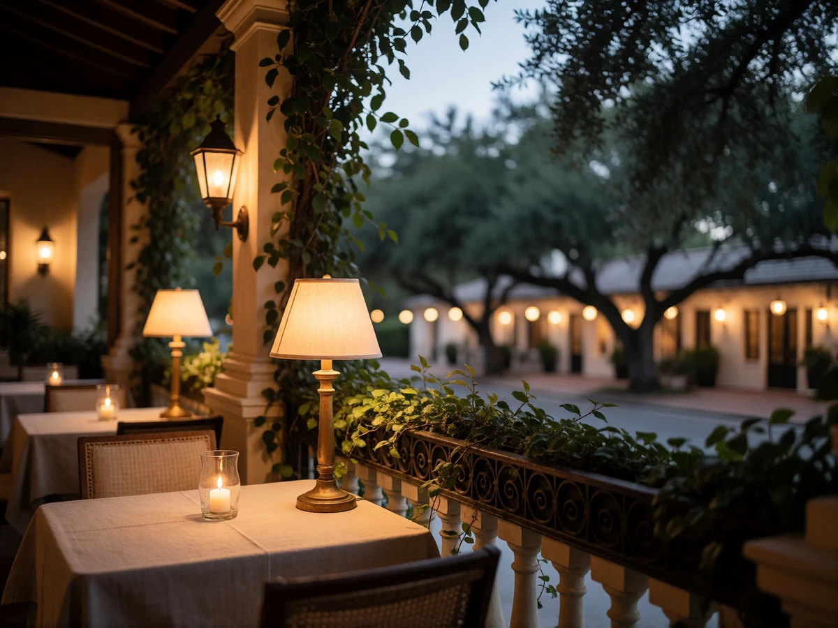 Candlelit open-air restaurant terrace in Winter Park with linen-covered tables and a tree-lined street beyond