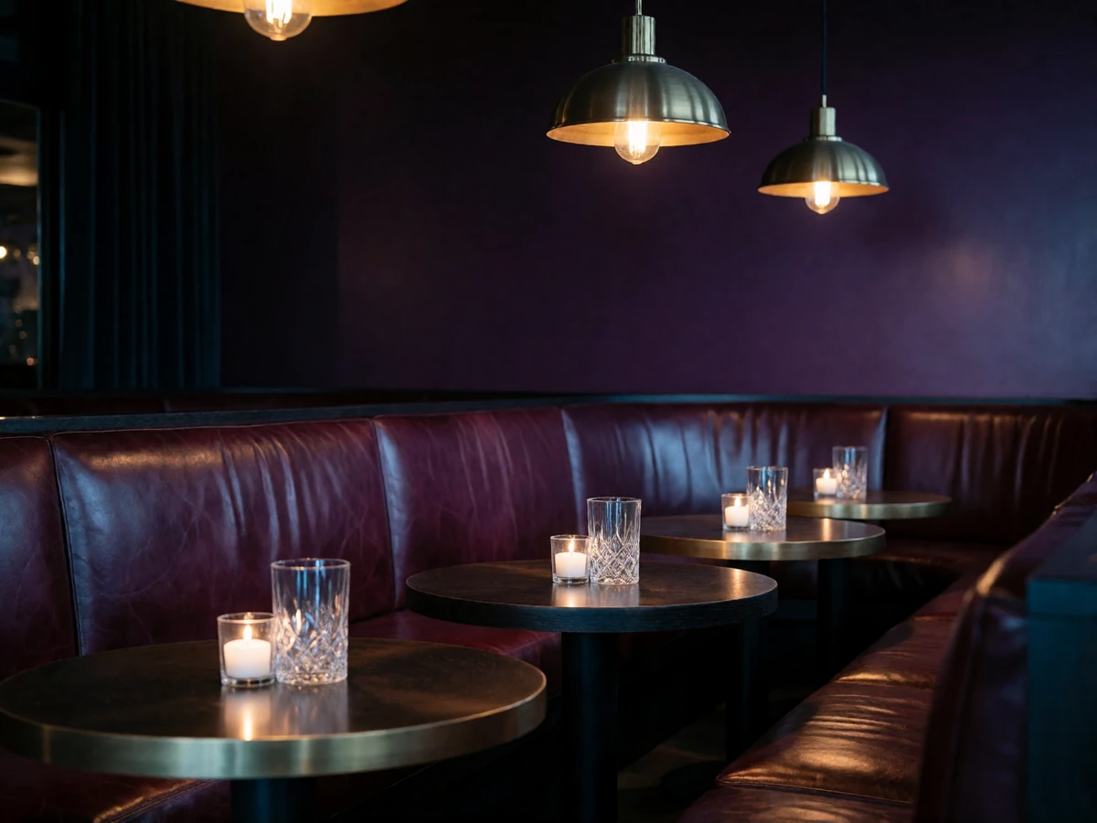 Empty upscale listening-room lounge in Nashville with leather banquettes and candlelit tables at night
